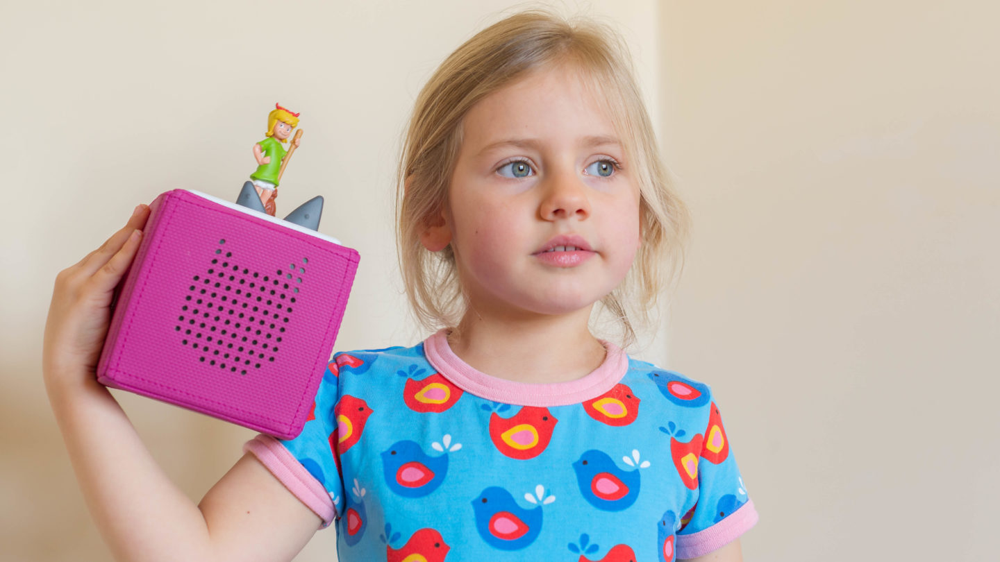 Toniebox audio player held by little girl